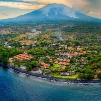 Aerial view of Tulamben in Bali with the volcano Mount Agung behind